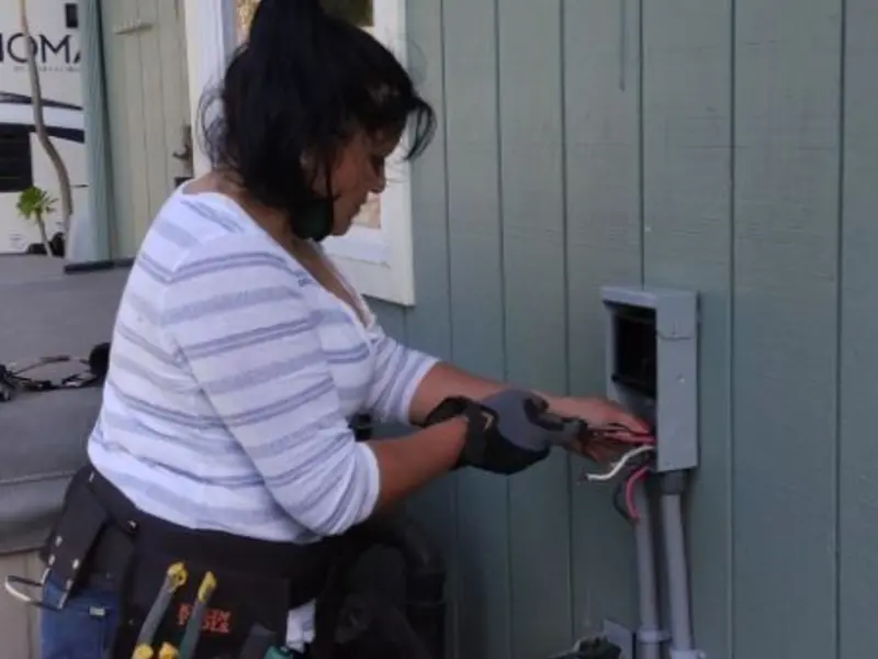 Licensed electrician wiring an exterior subpanel in Leroy